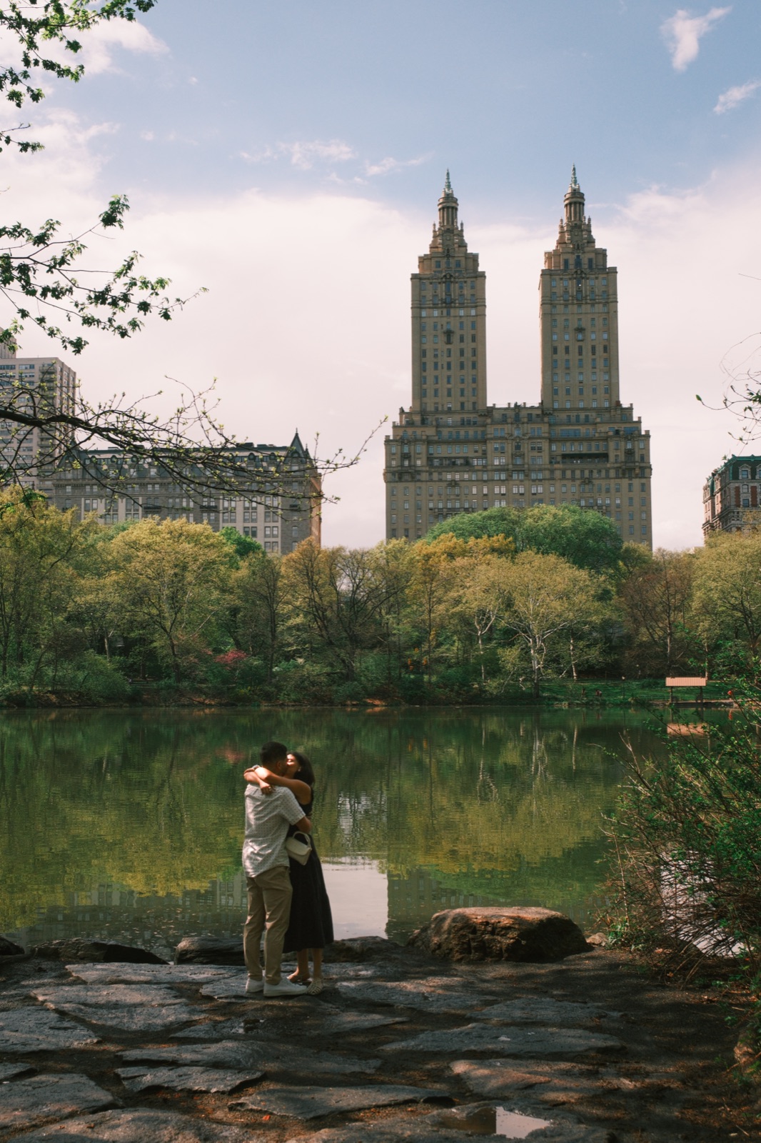 A couple embracing by the lake in Central Park, shot on film